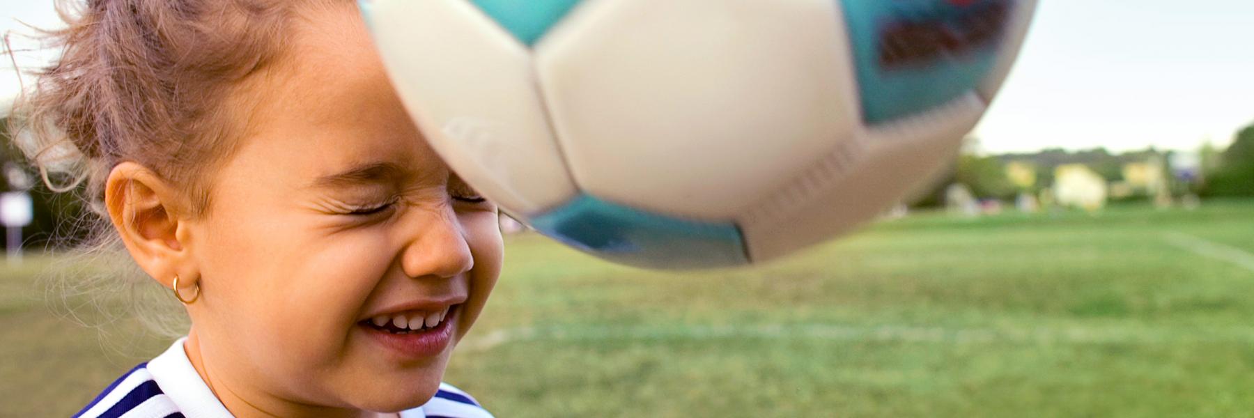 Little Girl Bouncing Soccer Ball